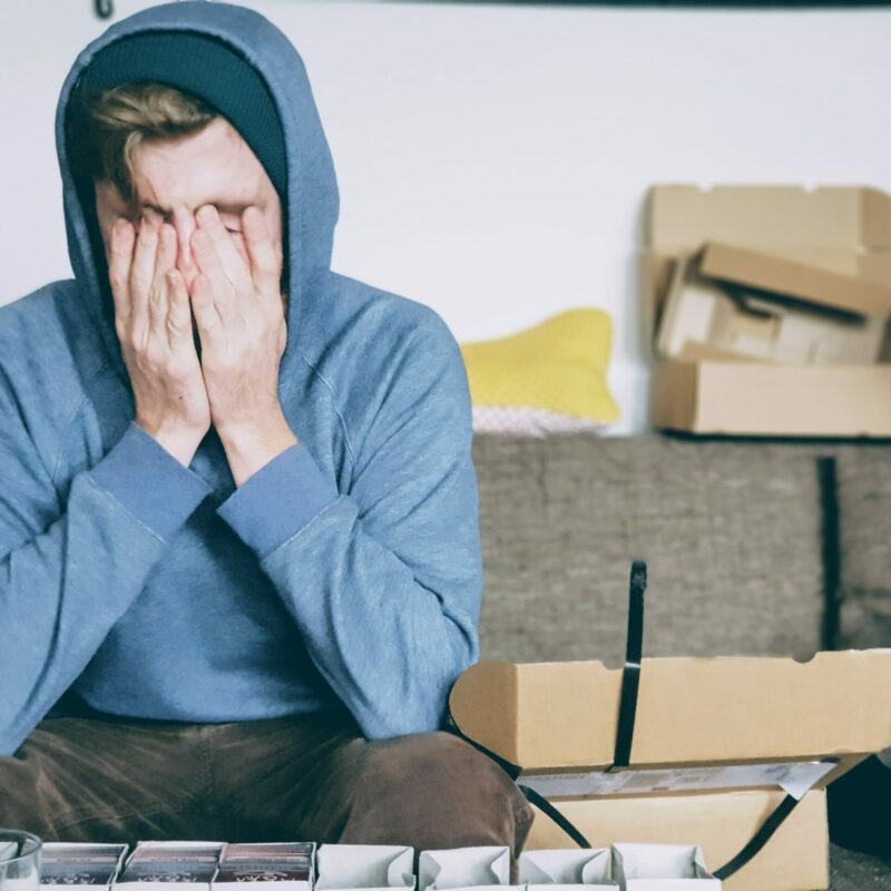 man sat with his head in his hands