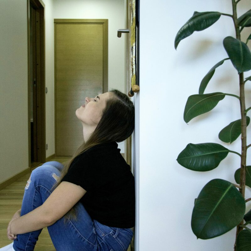 anxious woman against wall