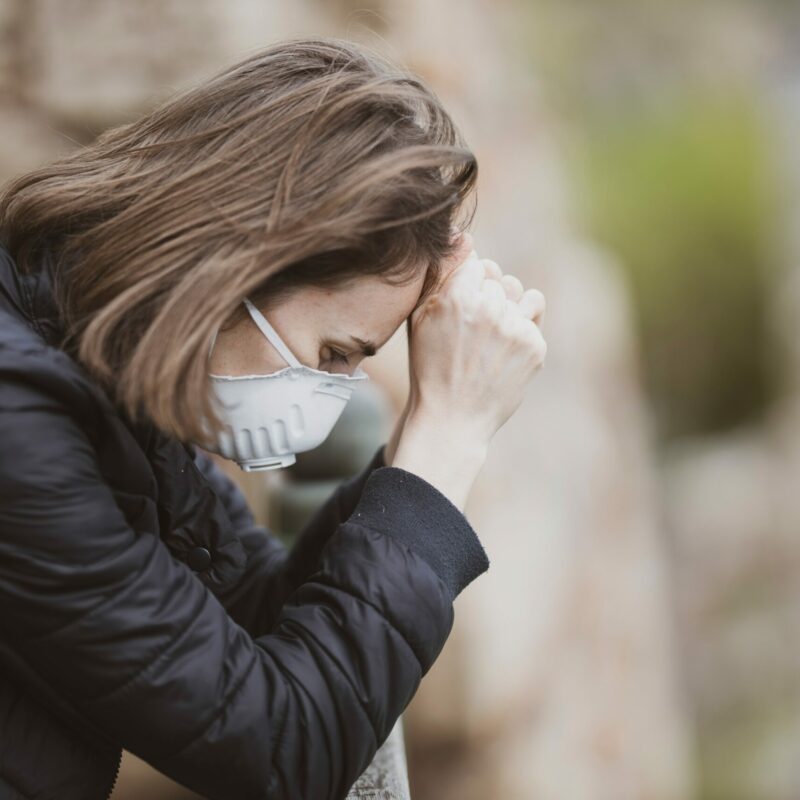 woman leaning over wall traumatised