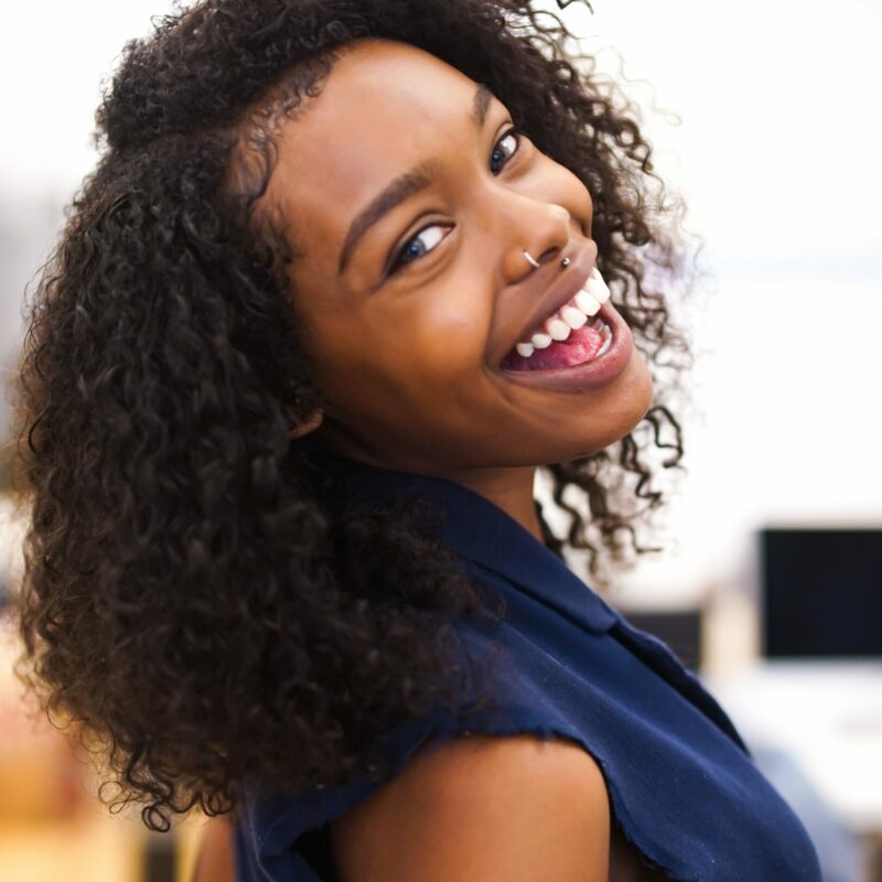 Young woman looking back and smiling