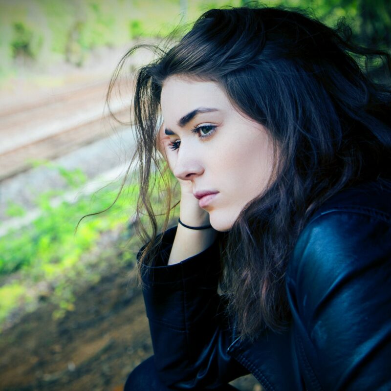 Girl looking depressed by the window